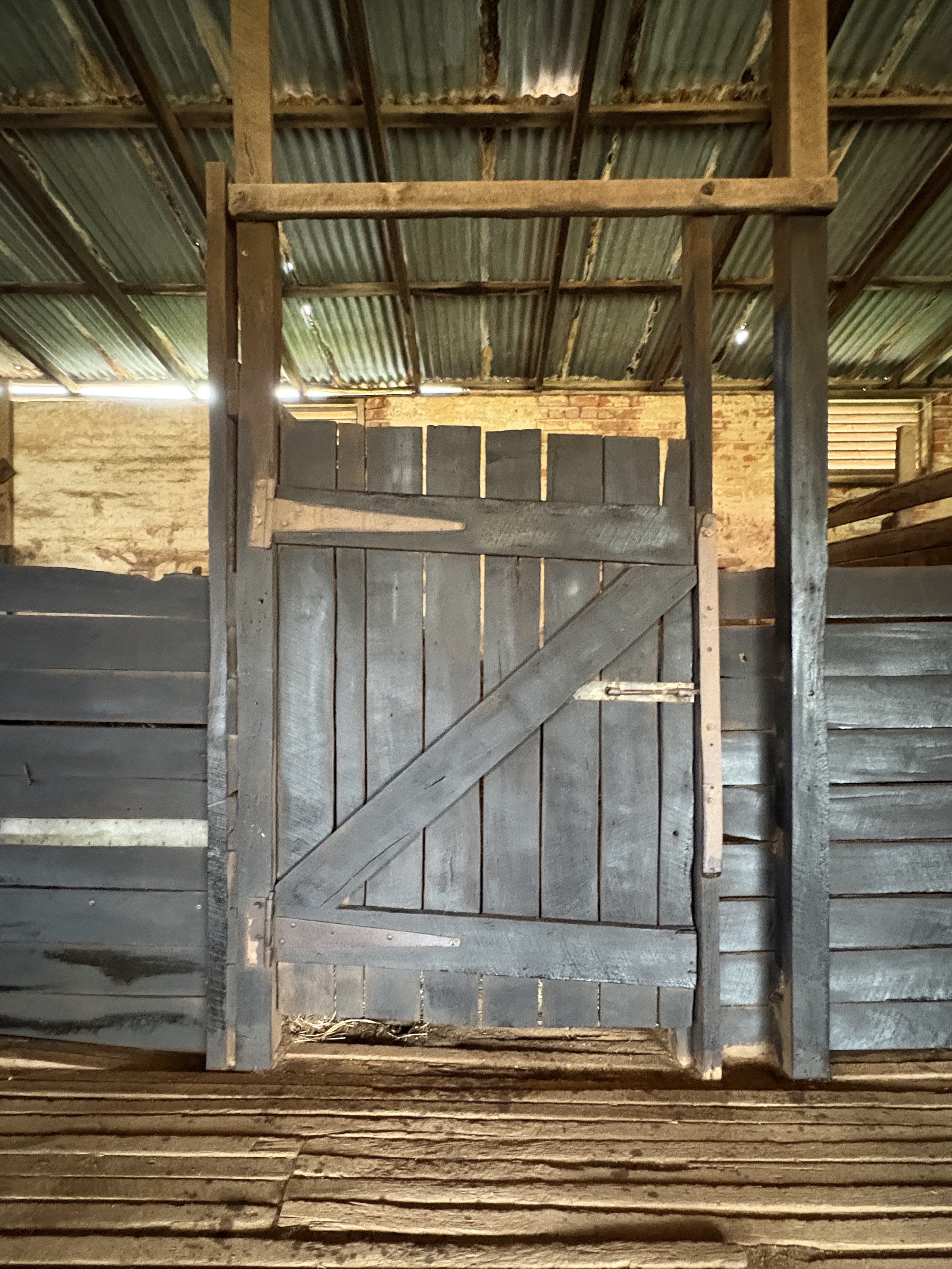 The stable door and brick wall inside the stables at Guildford Farm, freshly painted